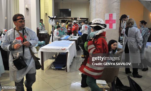 Medics and volunteers arrange a field hospital an hotel hall near Independence square in Kiev on February 20, 2014. As deadly clashes raged between...