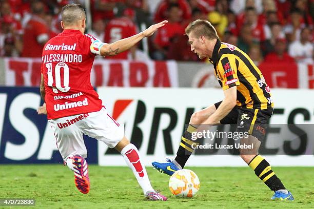 Andres Dalessandro of Internacional battles for the ball against Chumacero of The Strongest during match between Internacional and The Strongest as...