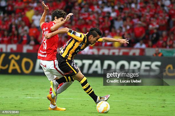 Rodrigo Dourado of Internacional battles for the ball against Pablo Escobar of The Strongest during match between Internacional and The Strongest as...