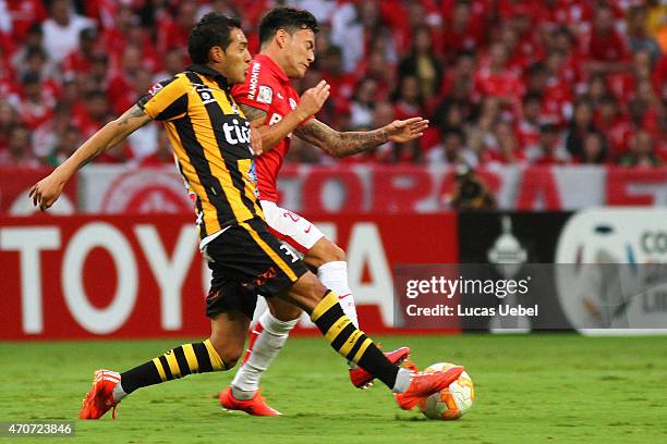 Charles Aranguiz of Internacional battles for the ball against Walter Veizaga of The Strongest during match between Internacional and The Strongest...