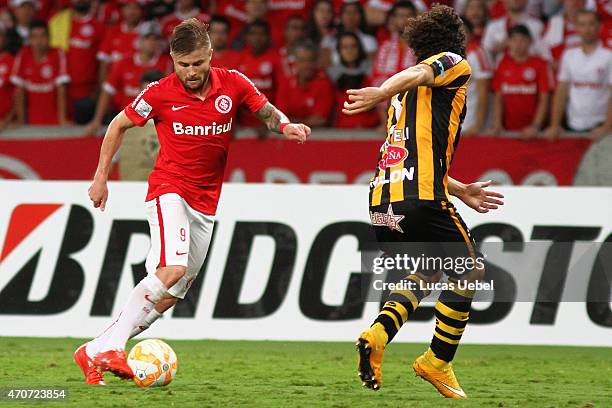 Eduardo Sasha of Internacional battles for the ball against Luis Fernando Dias of The Strongest during match between Internacional and The Strongest...