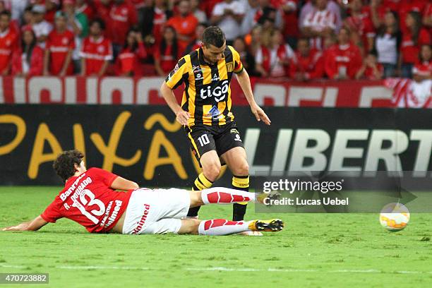 Rodrigo Dourado of Internacional battles for the ball against Pablo Escobar of The Strongest during match between Internacional and The Strongest as...