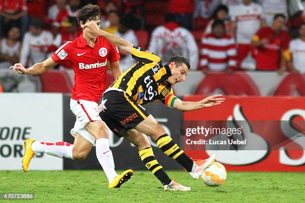 Rodrigo Dourado of Internacional battles for the ball against Pablo Escobar of The Strongest during match between Internacional and The Strongest as...