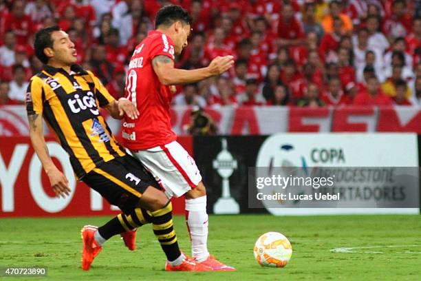 Charles Aranguiz of Internacional battles for the ball against Walter Veizaga of The Strongest during match between Internacional and The Strongest...