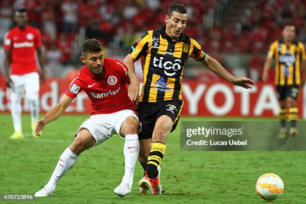 Alex of Internacional battles for the ball against Pablo Escobar of The Strongest during match between Internacional and The Strongest as part of...