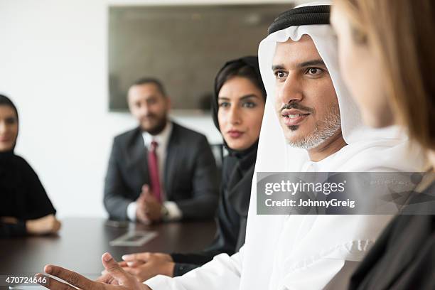 arab businessman talking in a meeting - united arab emirates culture stock pictures, royalty-free photos & images