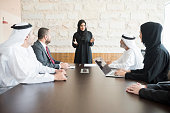 Arab businesswoman giving presentation to colleagues in office