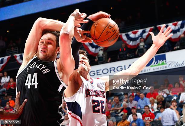 Bojan Bogdanovic of the Brooklyn Nets draws a foul as Kyle Korver of the Atlanta Hawks attempts to strip the ball during Game Two of the Eastern...