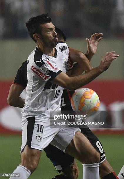 Datolo , of Brazil's Atletico Mineiro vies for the ball with and Esteban Pavez of Chile's Colo Colo during their 2015 Libertadores Cup match at the...