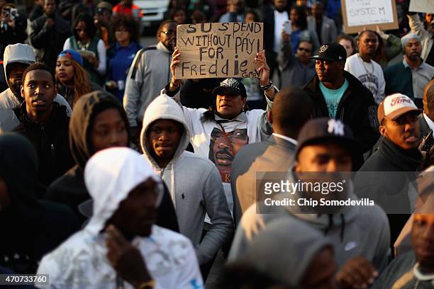 Hundreds of demonstrators gather outside the Baltimore Police Western District station during a protest against police brutality and the death of...