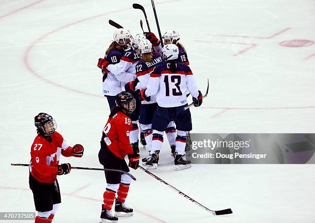 Tara Watchorn and Catherine Ward of Canada react as Meghan Duggan of the United States celebrates with teammates Julie Chu, Kacey Bellamy, Jocelyne...