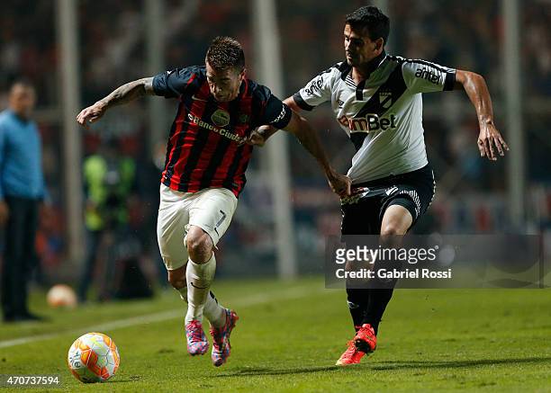 Julio Buffarini of San Lorenzo fights for the ball with Luis Sosa of Danubio during a match between San Lorenzo v Danubio as part of Copa Bridgestone...