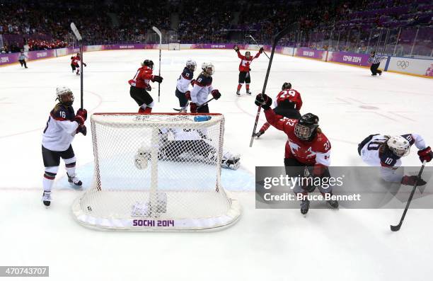 Marie-Philip Poulin of Canada celebrates her goal with teammates against Jessie Vetter of the United States late in the third period during the Ice...