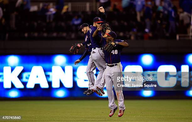 Outfielders Shane Robinson, Jordan Schafer and Torii Hunter of the Minnesota Twins celebrate after the twins defeated the Kansas City Royals 3-0 to...