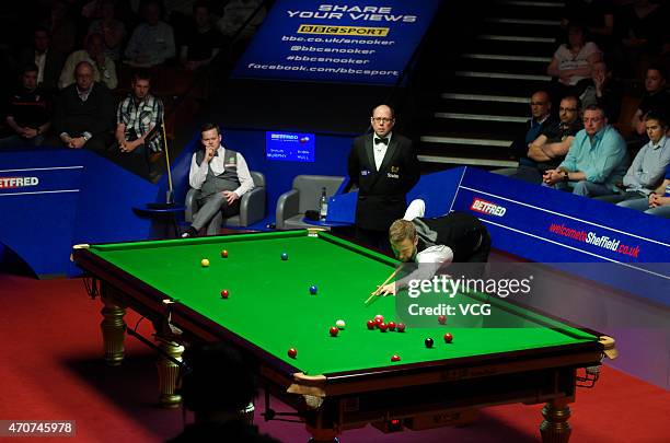 Robin Hull of Finland plays a shot in the match against Shaun Murphy of England during day five of the 2015 Betfred World Snooker Championship at...
