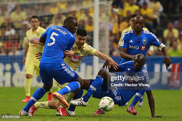 Oribe Peralta of America struggles for the ball with Bakary Soumare and Hassoun Camara of Montreal Impact during a Championship first leg match...