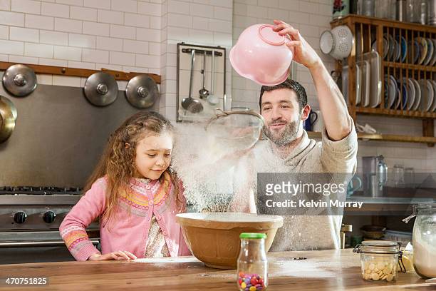 birthday cake baking with daddy - london not hipster not couple not love not sporty not businessman not businesswoman not young man no stockfoto's en -beelden