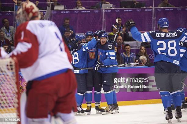 Winter Olympics: Finland Juhamatti Aaltonen victorious with Juuso Hietanen and Petri Kontiola after scoring game tying goal vs Russia during 1st...