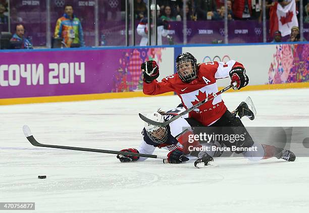 Hilary Knight of the United States and Hayley Wickenheiser of Canada dive for the puck during the Ice Hockey Women's Gold Medal Game on day 13 of the...