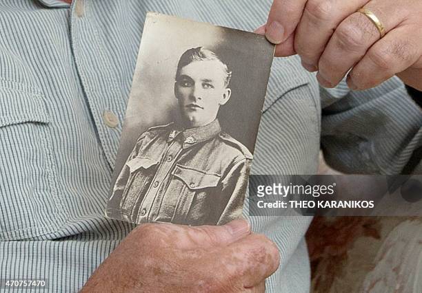 Australia-history-WWI-Gallipoli-graves,FEATURE by Madeleine Coorey This photo taken on April 17, 2015 shows Allan Grant holding a photo of his great...