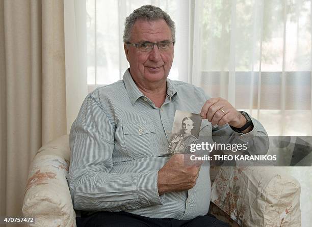 Australia-history-WWI-Gallipoli-graves,FEATURE by Madeleine Coorey This photo taken on April 17, 2015 shows Allan Grant holding a photo of his great...