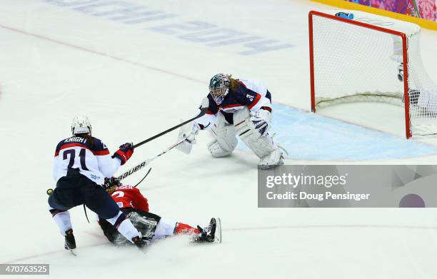 Hilary Knight of the United States cross-checks Hayley Wickenheiser of Canada during the Ice Hockey Women's Gold Medal Game on day 13 of the Sochi...