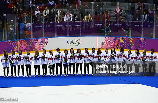 Bronze medalists Switzerland react during the flower ceremony for the Ice Hockey Women's Gold Medal Game on day 13 of the Sochi 2014 Winter Olympics...