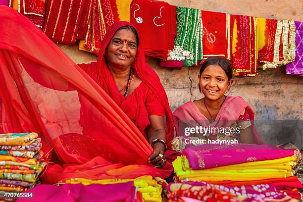 indian women selling colorful fabrics - fabric shop stock pictures, royalty-free photos & images