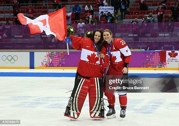 Gold medalists Shannon Szabados and Hayley Wickenheiser of Canada celebrate during the flower ceremony after defeating the United States 3-2 in...