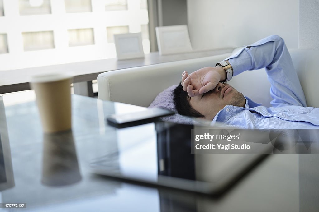 Business man sleeping on the sofa in office