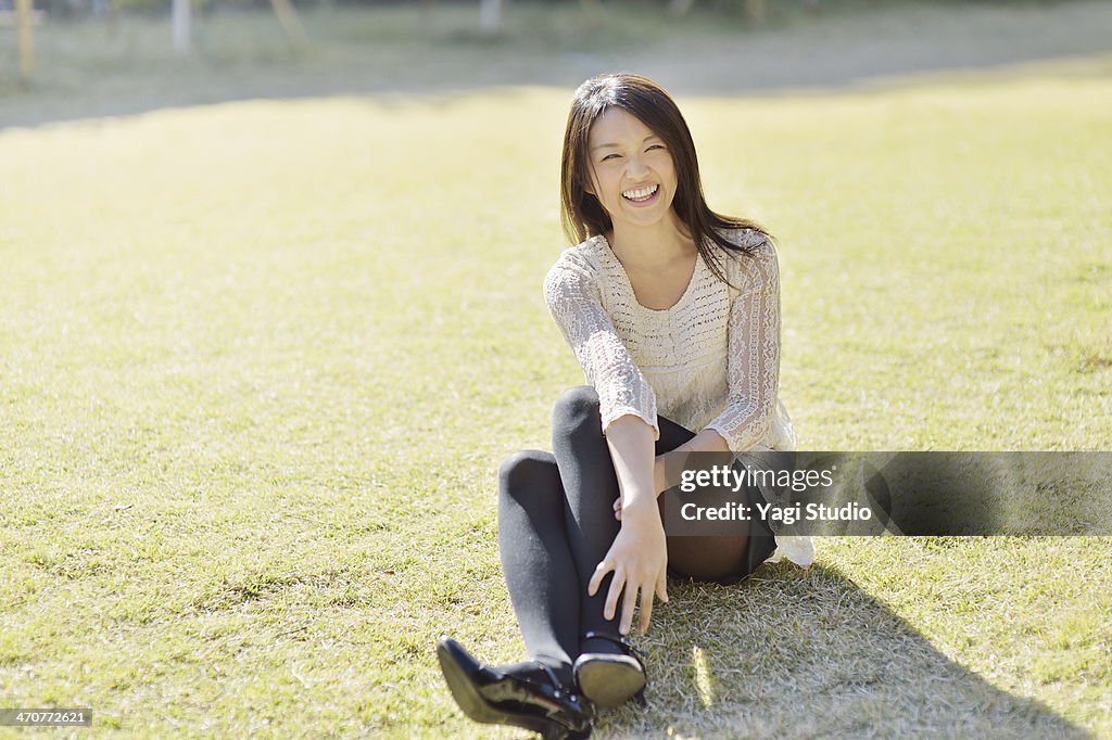 Smiling woman sitting on the grass