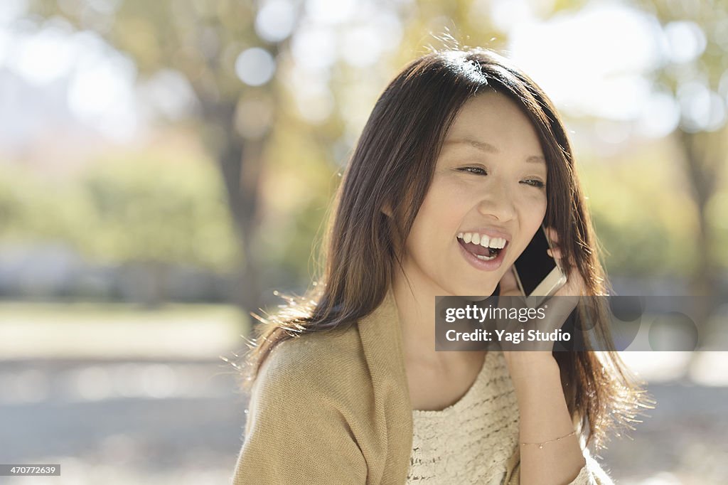 Woman using Smartphone in park