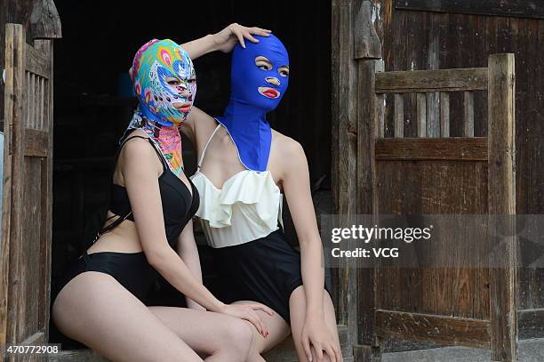 Models wearing face-kinis pose on the terraces of a farm on World Earth Day on April 22, 2015 in Loudi, Hunan province of China.