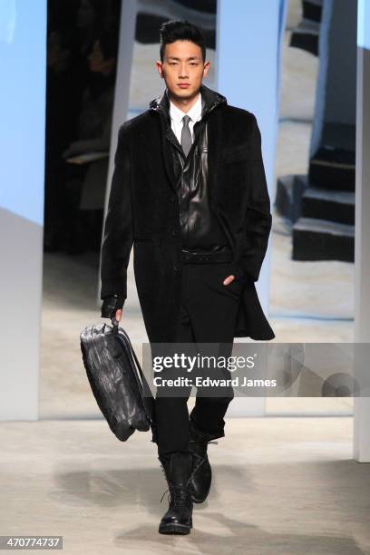 Model walks the runway at the Kenneth Cole Collection fashion show during Mercedes-Benz Fashion Week Fall 2014 at The Garage at Lincoln Center on...