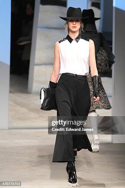 Model walks the runway at the Kenneth Cole Collection fashion show during Mercedes-Benz Fashion Week Fall 2014 at The Garage at Lincoln Center on...