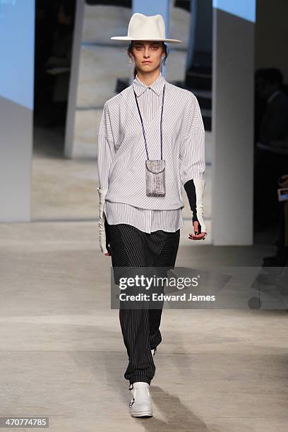 Model walks the runway at the Kenneth Cole Collection fashion show during Mercedes-Benz Fashion Week Fall 2014 at The Garage at Lincoln Center on...