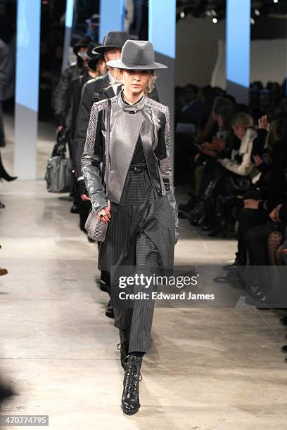 Model walks the runway at the Kenneth Cole Collection fashion show during Mercedes-Benz Fashion Week Fall 2014 at The Garage at Lincoln Center on...