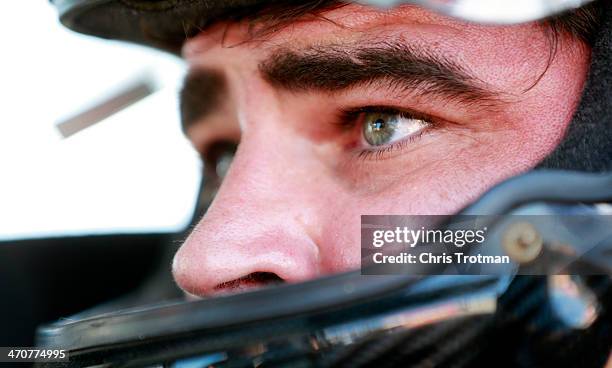 Jason White, driver of the RSS Racing Chevrolet, sits in his truck in the garage area during practice for the NASCAR Camping World Series NextEra...