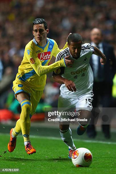 Wayne Routledge of Swansea City forces his way past Jose Callejon of SSC Napoli during the UEFA Europa League Round of 32 First Leg match between...