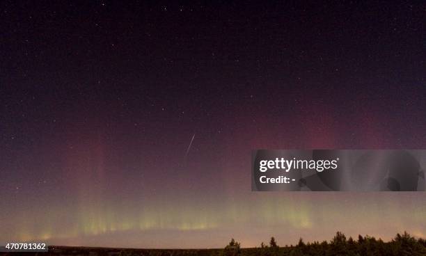 View of a shooting star and northern light near Skekarsbo at the Farnebofjardens national park 150 kilometers north of Stockholm, late on October 8,...