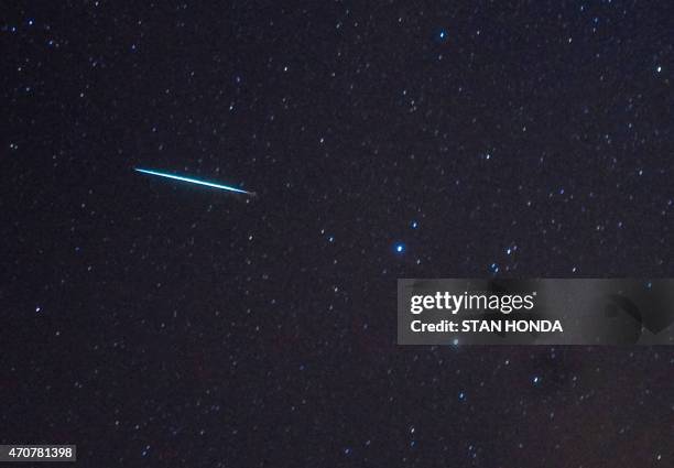 Meteor from the Geminids meteor shower enters the Earth's atmosphere past the stars Castor and Pollux on December 12, 2009 above Southold, New York....