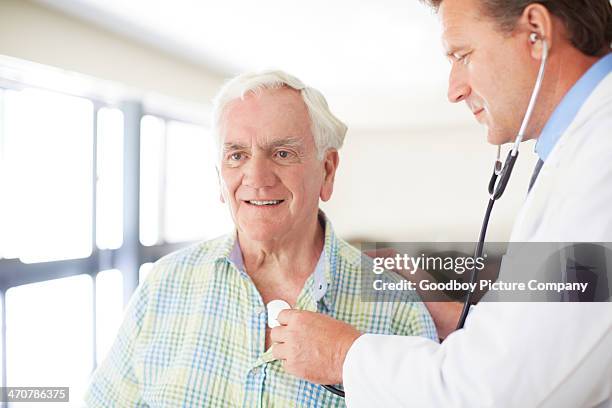 letting his physician perform a checkup - old man chest stock pictures, royalty-free photos & images