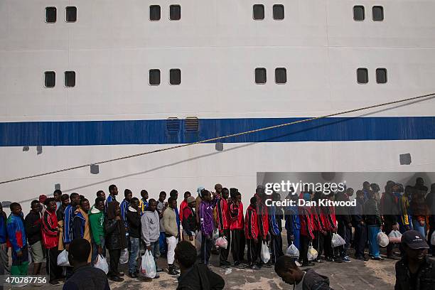 Migrant men wait in line to board a ship bound for Sicily on April 23, 2015 in Lampedusa, Italy. It is expected that EU leaders in Brussels are to...