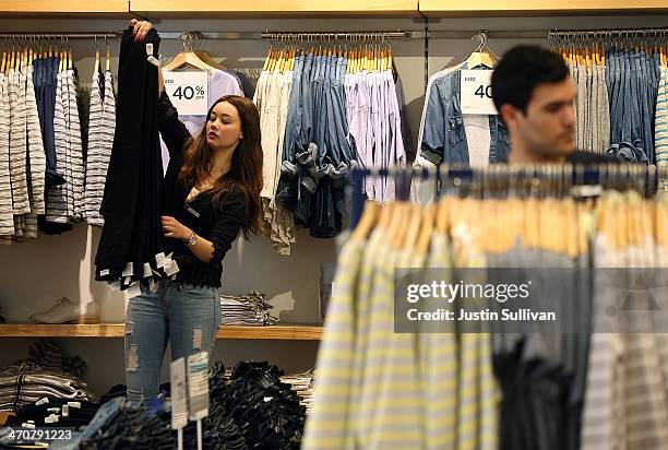 Gap employee Shinju Nozawa-Auclair folds clothes at a Gap store on February 20, 2014 in San Francisco, California. Gap Inc. Announced that they will...