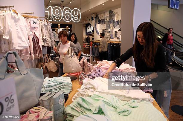 Gap employee Shinju Nozawa-Auclair folds clothes at a Gap store on February 20, 2014 in San Francisco, California. Gap Inc. Announced that they will...