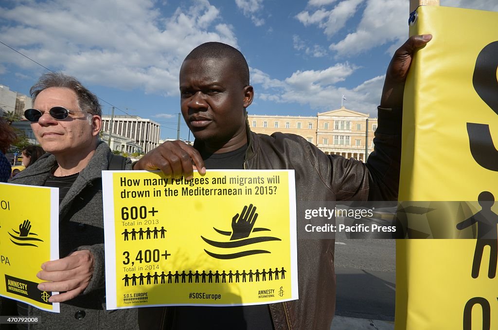 A immigrant holds a message against further deaths of...