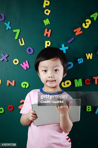 boy with tablet - number magnet stock pictures, royalty-free photos & images