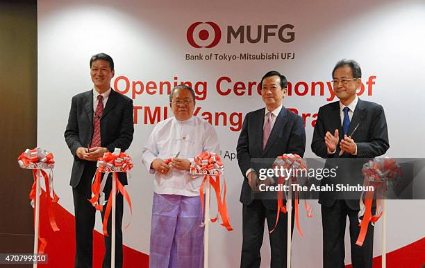 Officials from the Bank of Tokyo-Mitsubishi UFJ Ltd., along with government representatives from Myanmar and Japan, attend a ribbon-cutting ceremony...