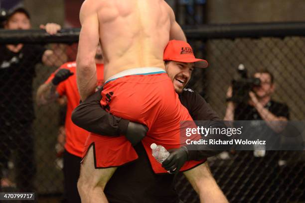 Team Canada coach Patrick Cote cheers on his fighter Sheldon Westcott after submitting Team Australia fighter Daniel Kelly in their middleweight...