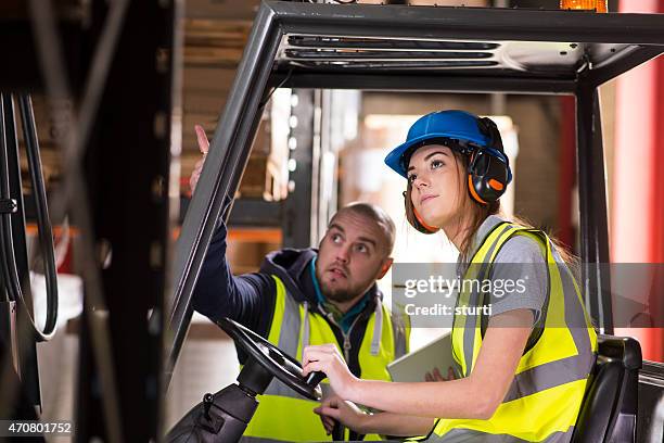 female forklift driver training - forklift stock pictures, royalty-free photos & images